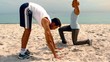 Friends doing yoga on the beach together