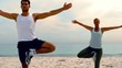 Friends in yoga positions on the beach