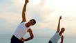 Friends in stretching together on the beach