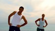Friends exercising  together on the beach