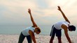 Friends stretching on the beach