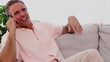 Mature man having a phone discussion on the couch