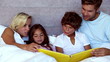 Parents reading a fairytale to their children