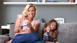 Mother and daughter playing video games