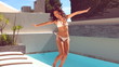 Pretty woman leaping beside swimming pool