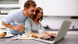 Woman showing her partner something on laptop
