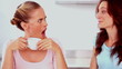 Woman telling her friend a secret