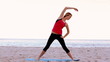 Woman stretching on the beach