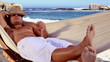 Attractive man relaxing in a hammock