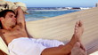 Attractive man napping in a hammock