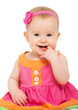 happy little sly baby girl in bright multicolored festive dress