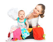 Mom and baby girl with suitcase and clothes ready for traveling