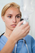 Focus on a nurse checking an intravenous drip