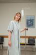 Woman walking while holding a drip stand