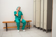 Tired nurse sitting on a bench