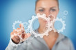 Businesswoman touching on wheels and cogs graphic
