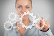 Businesswoman pressing wheels and cogs graphic