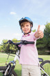 Happy boy giving thumbs up with his bike