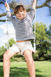 Portrait of happy boy on a swing