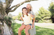 Mother pushing her daughter on a swing