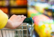 Closeup of female shopper with trolley at supermarket