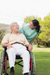 Nurse chatting with man in wheelchair