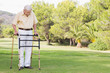 Elderly man using zimmer frame to walk