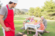 Family waiting for barbecue to be ready
