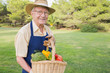 Elderly man carrying basket of vegetables