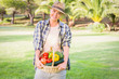 Pretty blonde carrying basket of home grown vegetables