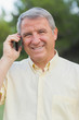 Smiling grey haired man on the phone