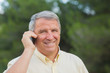 Grey haired man using his mobile portrait
