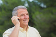 Grey haired man using his mobile