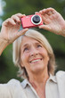 Older blonde woman taking a photo