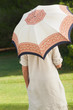 Rear view of woman holding umbrella