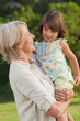 Woman holding her cute granddaughter