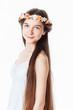 Portrait of a beautiful girl in a wreath, on a gray background