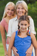 Three generations of women smiling together portrait