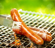 Foto: Grilled Sausage on the flaming Grill. BBQ. Bearbeque outdoors Grilled Sausage on the flaming Grill. BBQ. Bearbeque outdoors