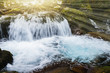 winte river with waterfall and sunrise