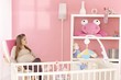 Pregnant mother sitting in baby's room