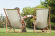Couple in deck chairs enjoying cups of coffee