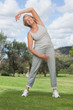 Mature woman stretching arms