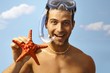 Photo: Portrait of happy scuba diver with starfish Portrait of happy scuba diver with starfish