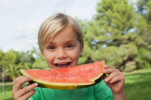 Photo: Cute blonde boy eating watermelon Cute blonde boy eating watermelon