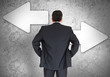 Businessman choosing which direction to go