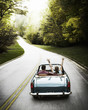 Vintage Car Couple. Woman's arms in the wind