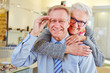 Foto: Happy senior couple with new glasses at optician Happy senior couple with new glasses at optician