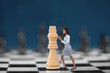 Businesswoman pushing chess piece