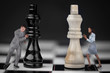 Businesspeople pushing chess pieces